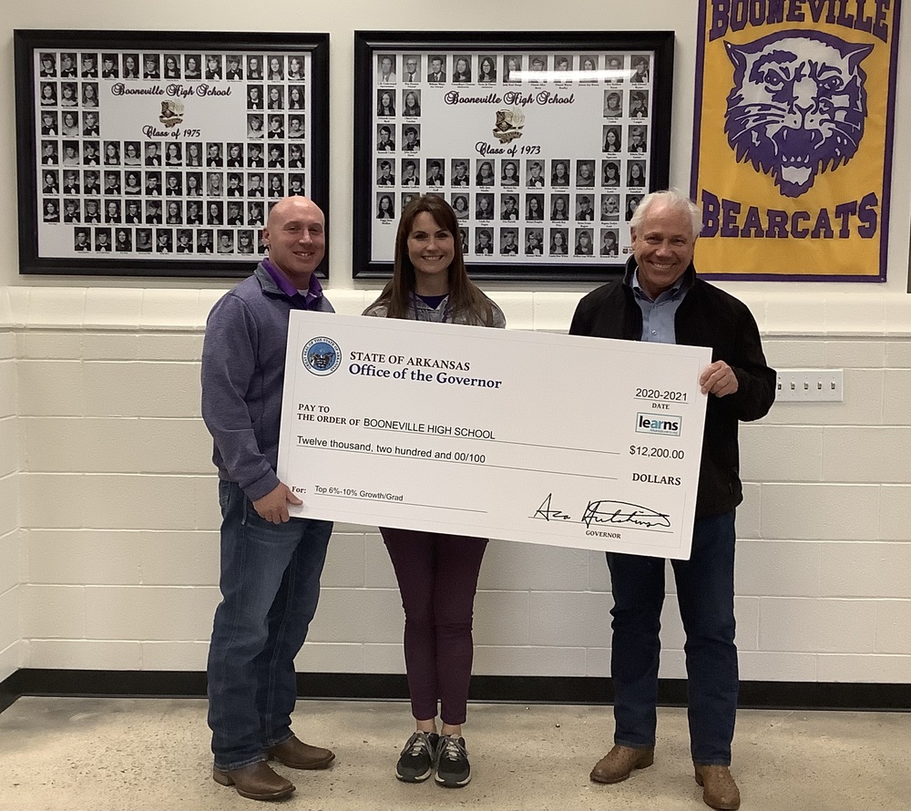 Superintendent Trent Goff (from left) and High School Principal Amy Goers Accept A $12,200 Check From State Rep. Jon Eubanks.